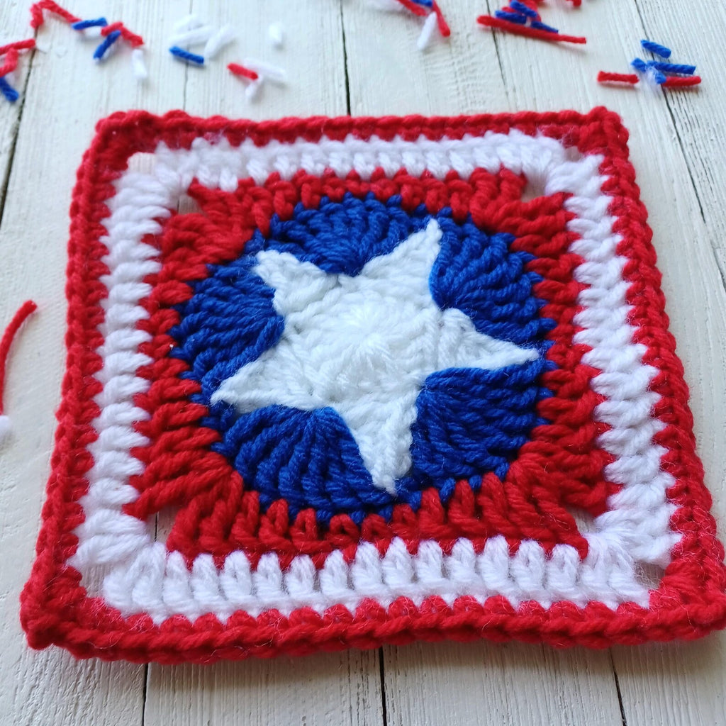 Crochet granny square afghan motif with patriotic blue-white star in red border