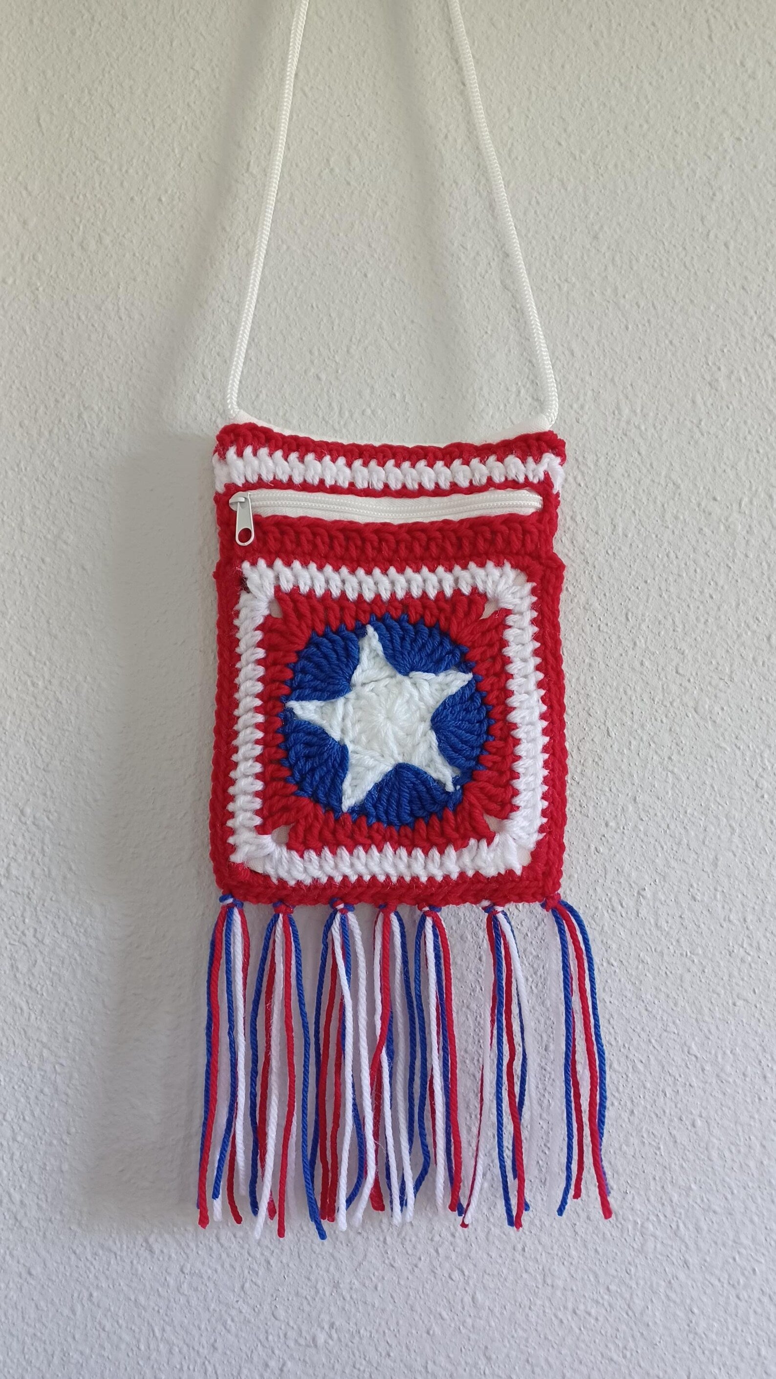 Patriotic crochet granny square bag with red, white, blue star panel and tassels