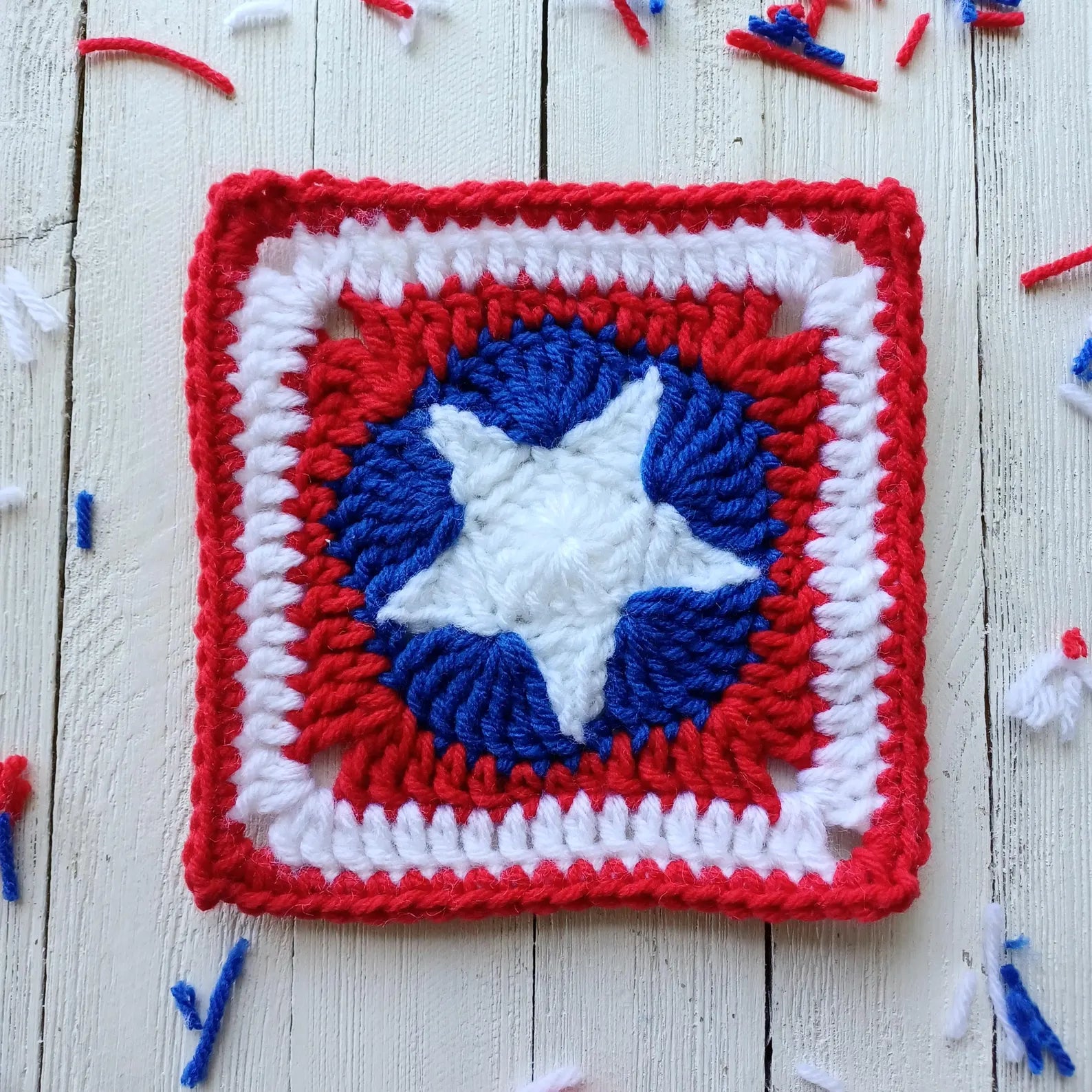 Patriotic crochet granny square with blue and white star center and red border